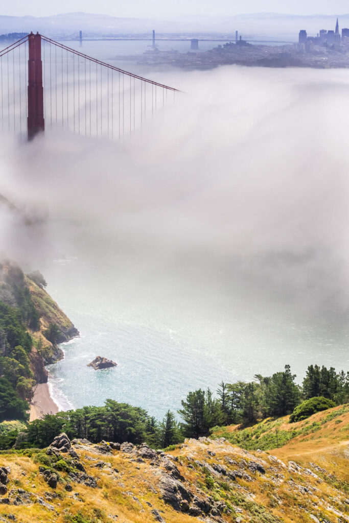 the Golden Gate Bridge shrouded in fog and barely visible