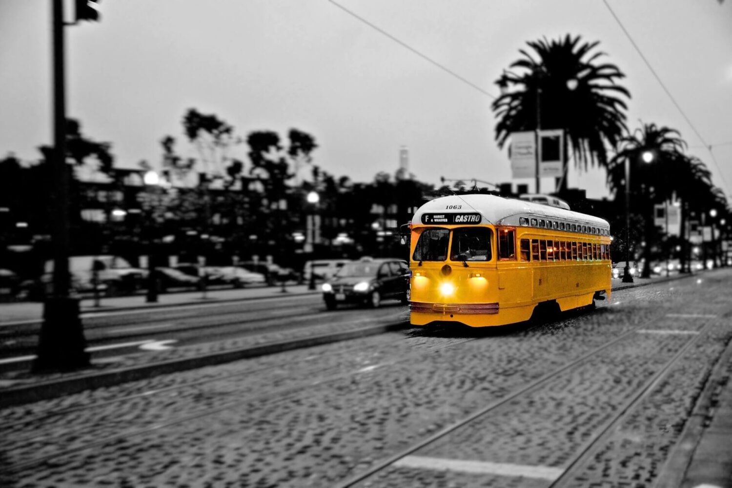 San Francisco F-Line tour in black and white with a bright yellow streetcar